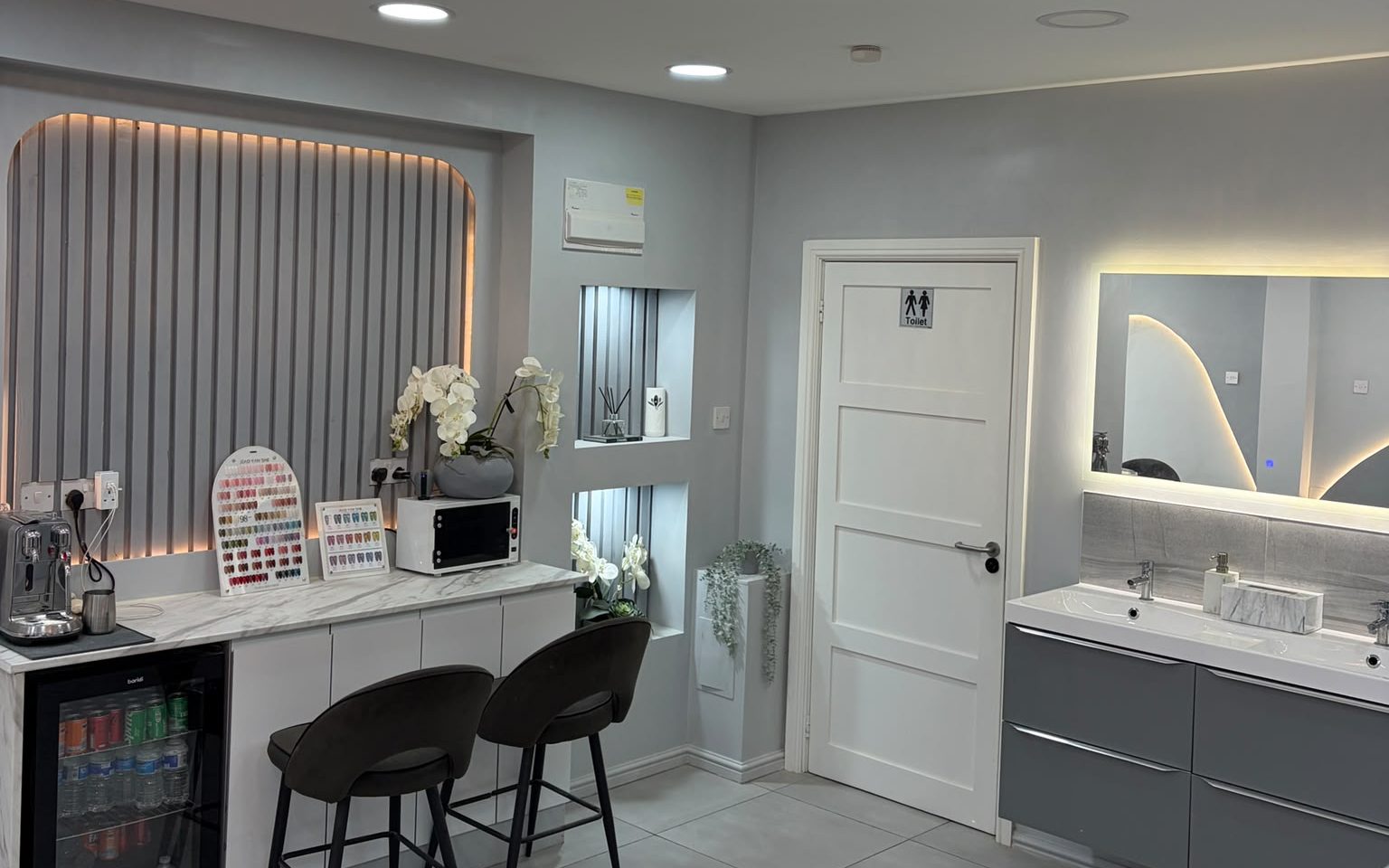 Inside Nails 4 U Great Barr — marble counter, nail colour displays, backlit mirrors and wash basins.